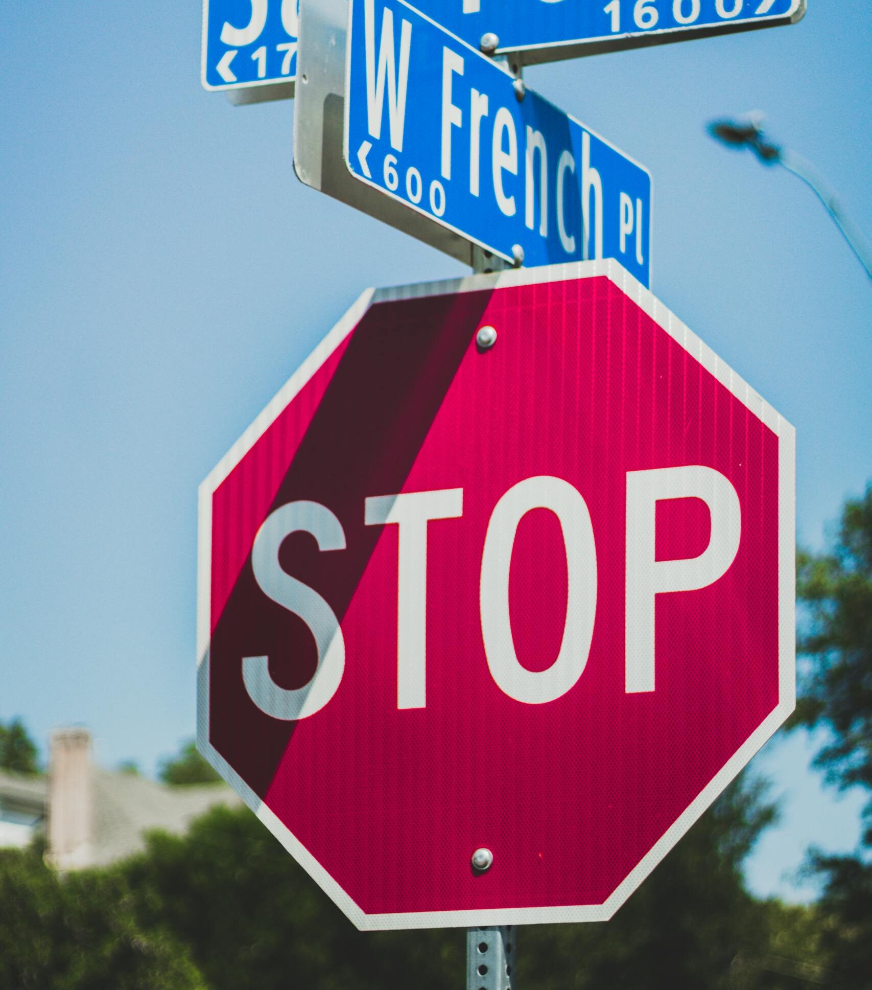 Intersection of San Pedro and W French with clear street signs and stop sign.